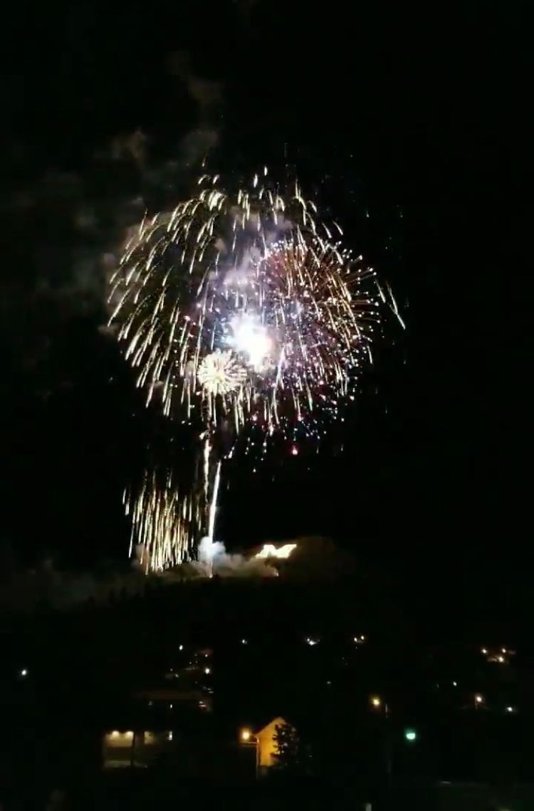 Fireworks exploding in the night sky over  Butte, MT