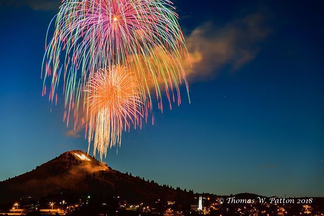 Fireworks exploding in the night sky over  Butte, MT