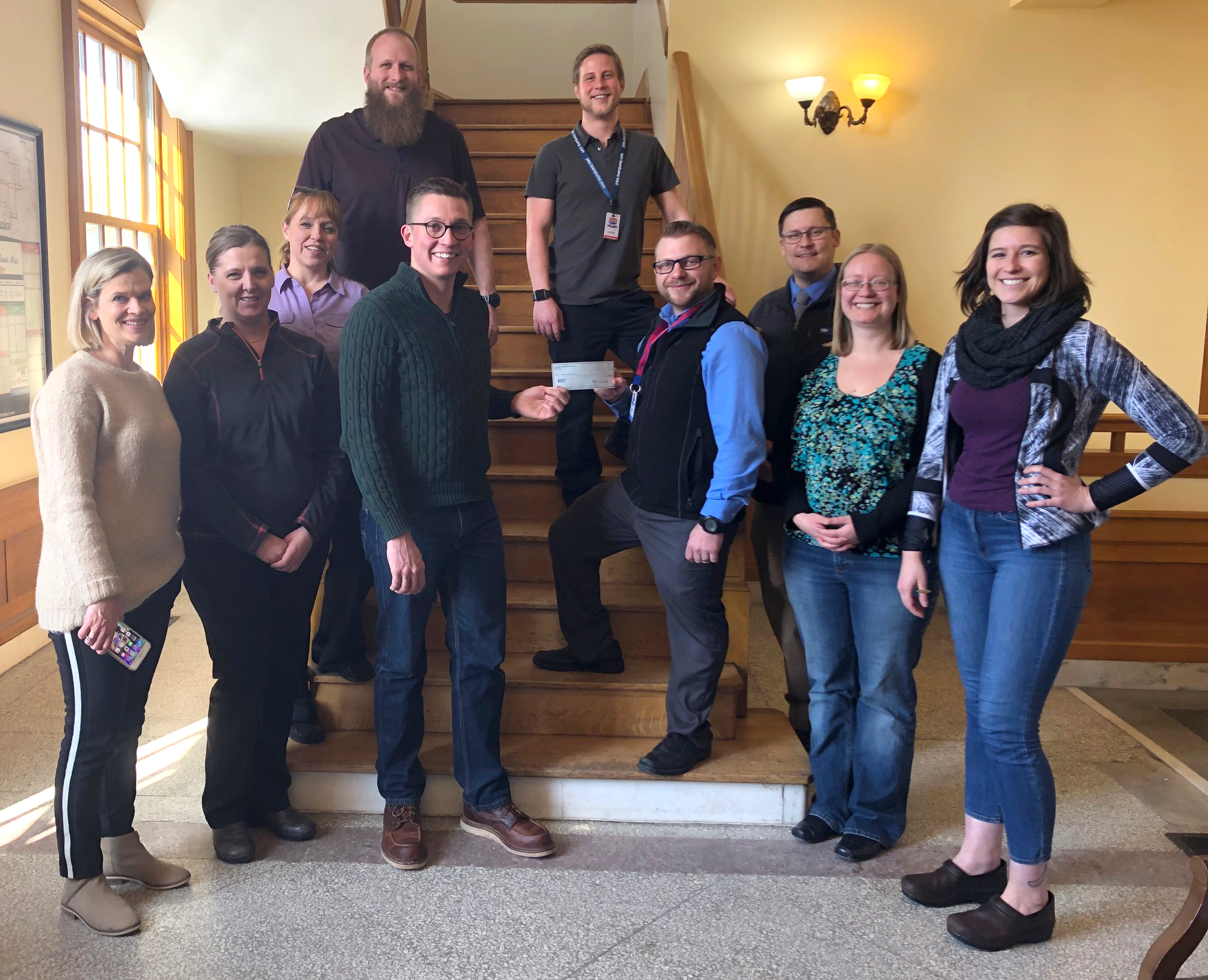Photo of Bozeman Warming Center staff accepting donation from Town Pump Charitable Foundation