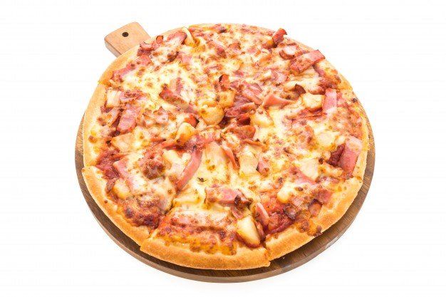 Photo of a pizza with canadian bacon & pineapple on it.