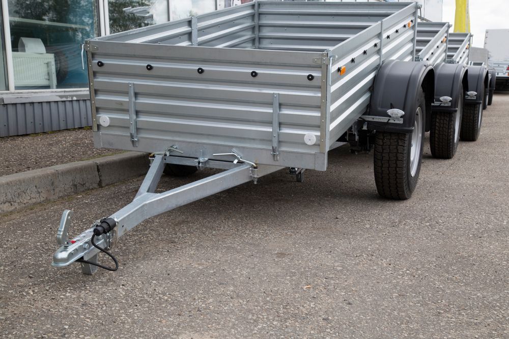 A Row of Trailers Are Parked on the Side of the Road — Docs Mobile Tyre Service In Kawana, QLD