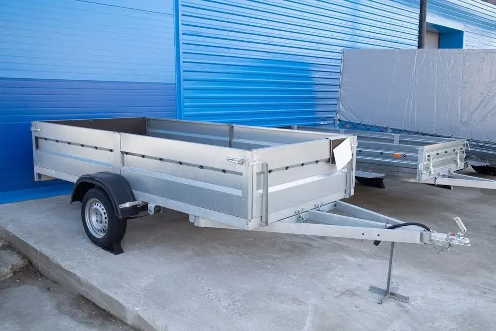 A Trailer is Parked in Front of a Blue Building — Docs Mobile Tyre Service In Buderim, QLD
