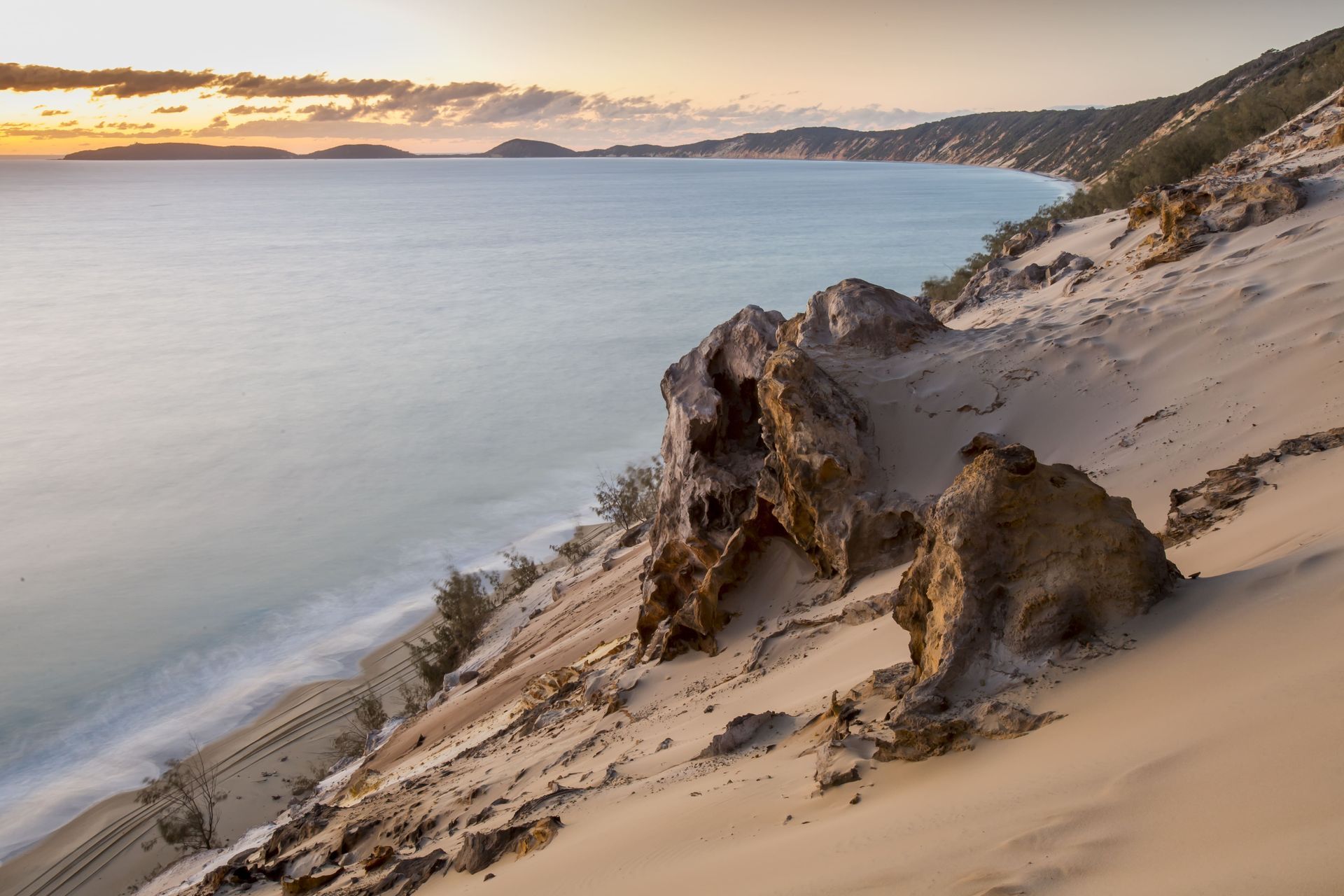 Sandy Beach With Rocky Outcrop Overlooking Calm Sea at Sunset — Docs Mobile Tyre Service In Gympie, QLD