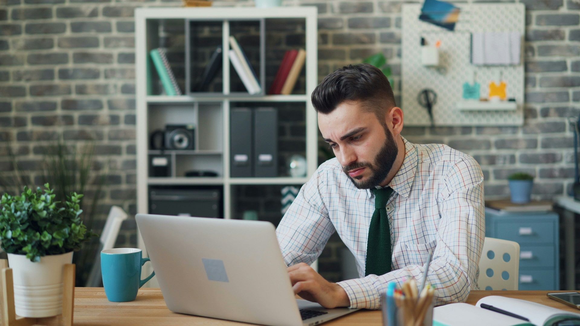 man hunched over laptop to depict bad posture and headaches