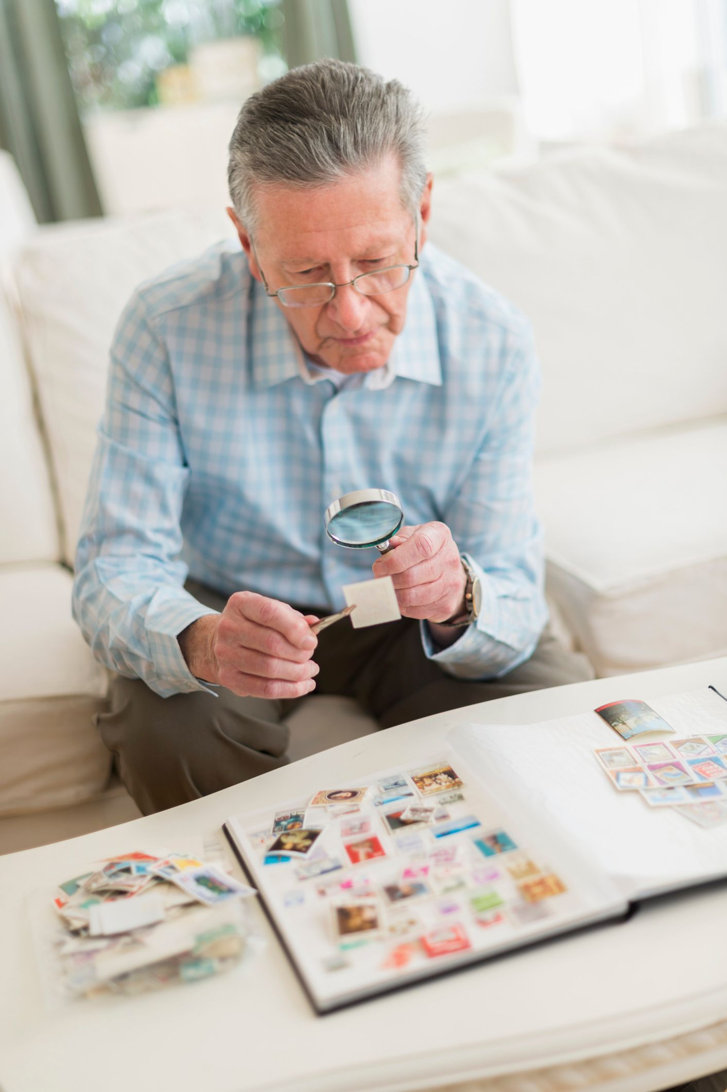 Elderly Man Looking For Stamp — Hills, MI — BC Coins and Stamps