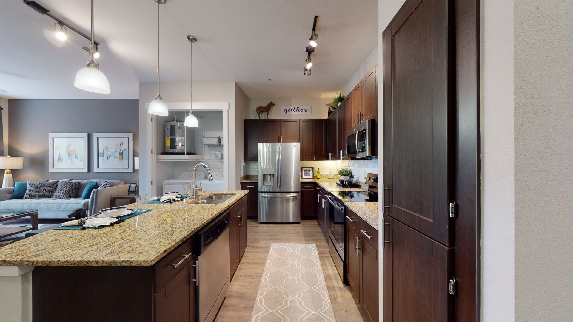 A kitchen with stainless steel appliances and granite counter tops.