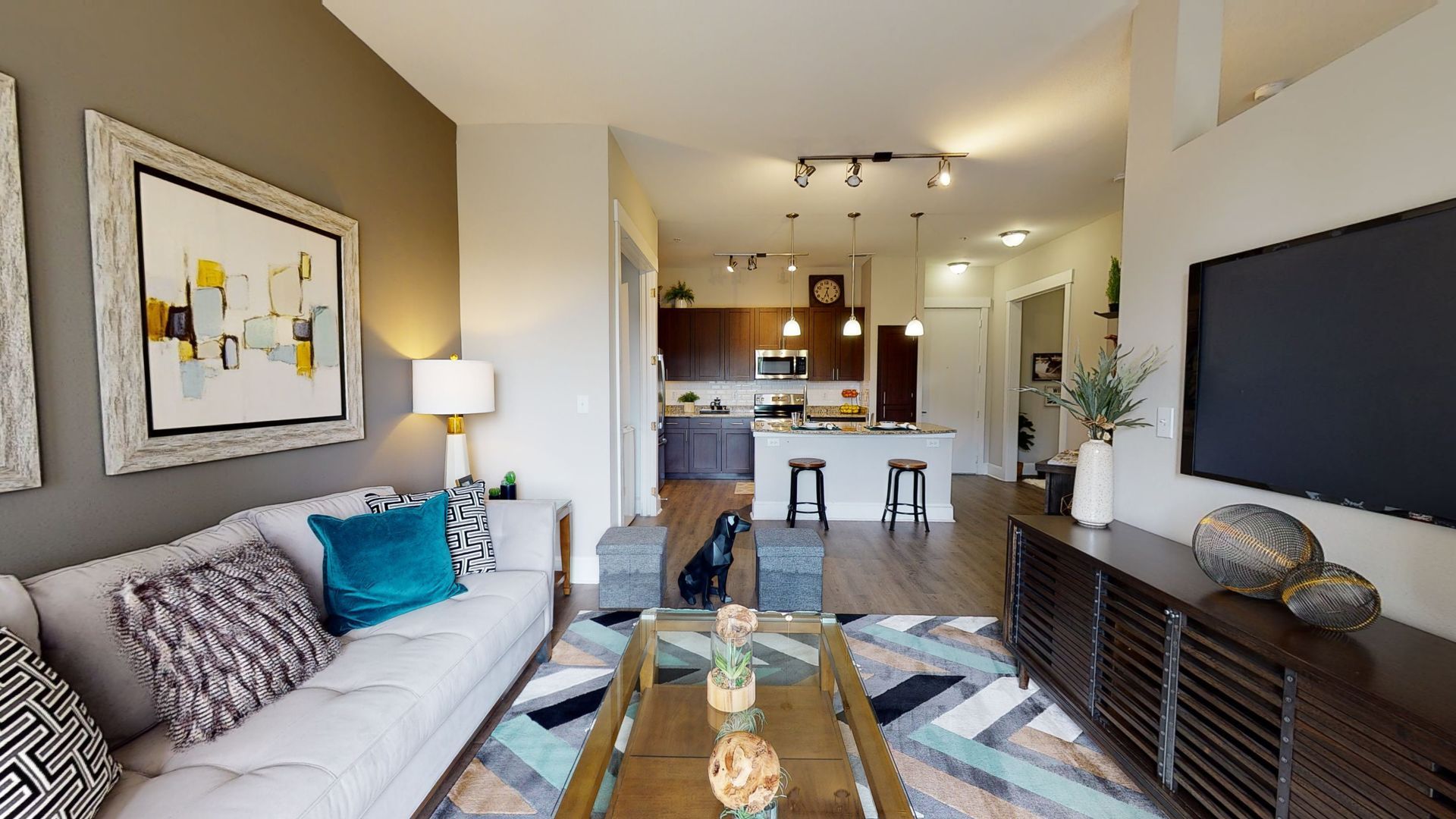 A living room with a couch , coffee table , and television.