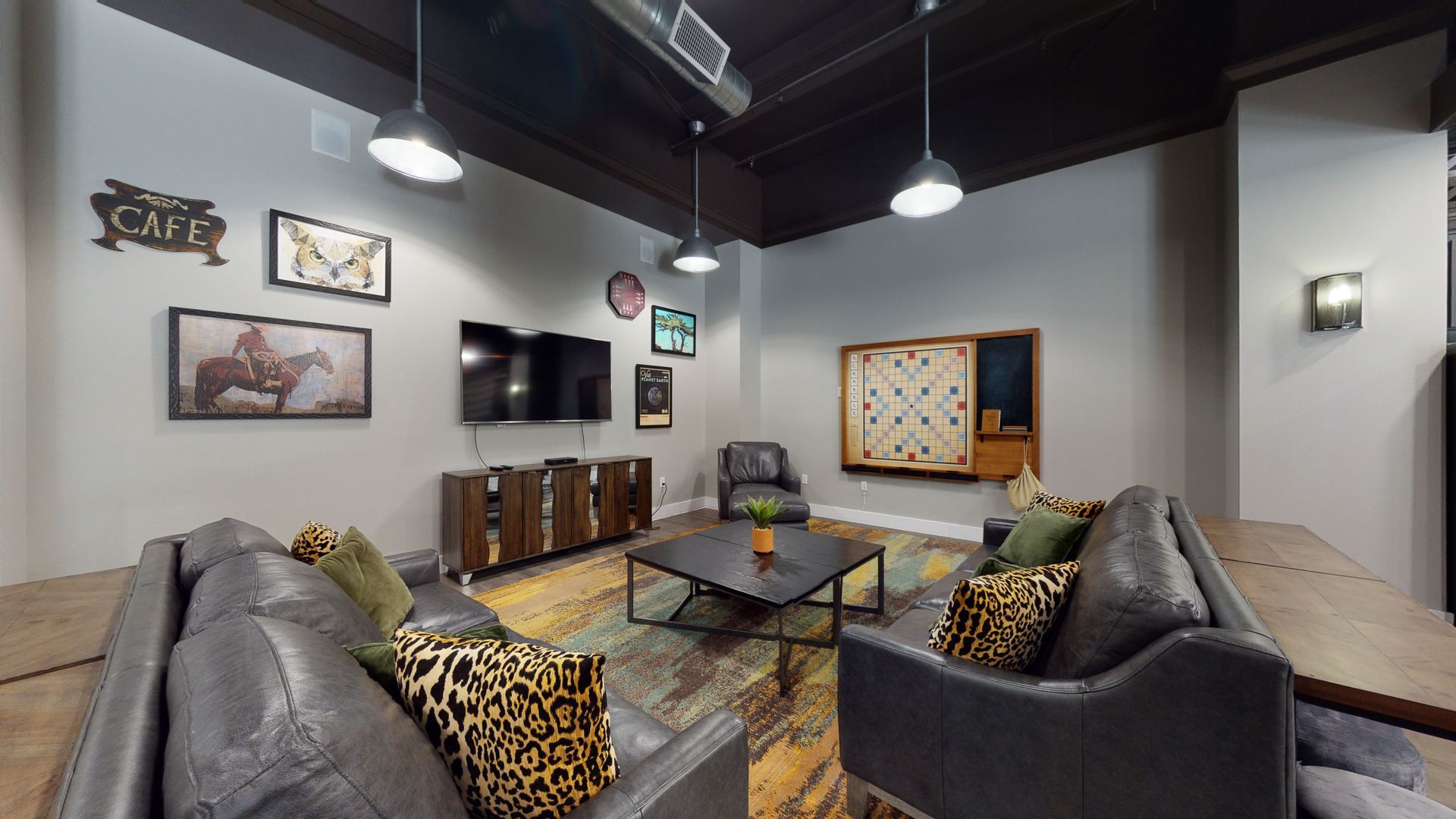 A living room with a couch , chairs , table and television.