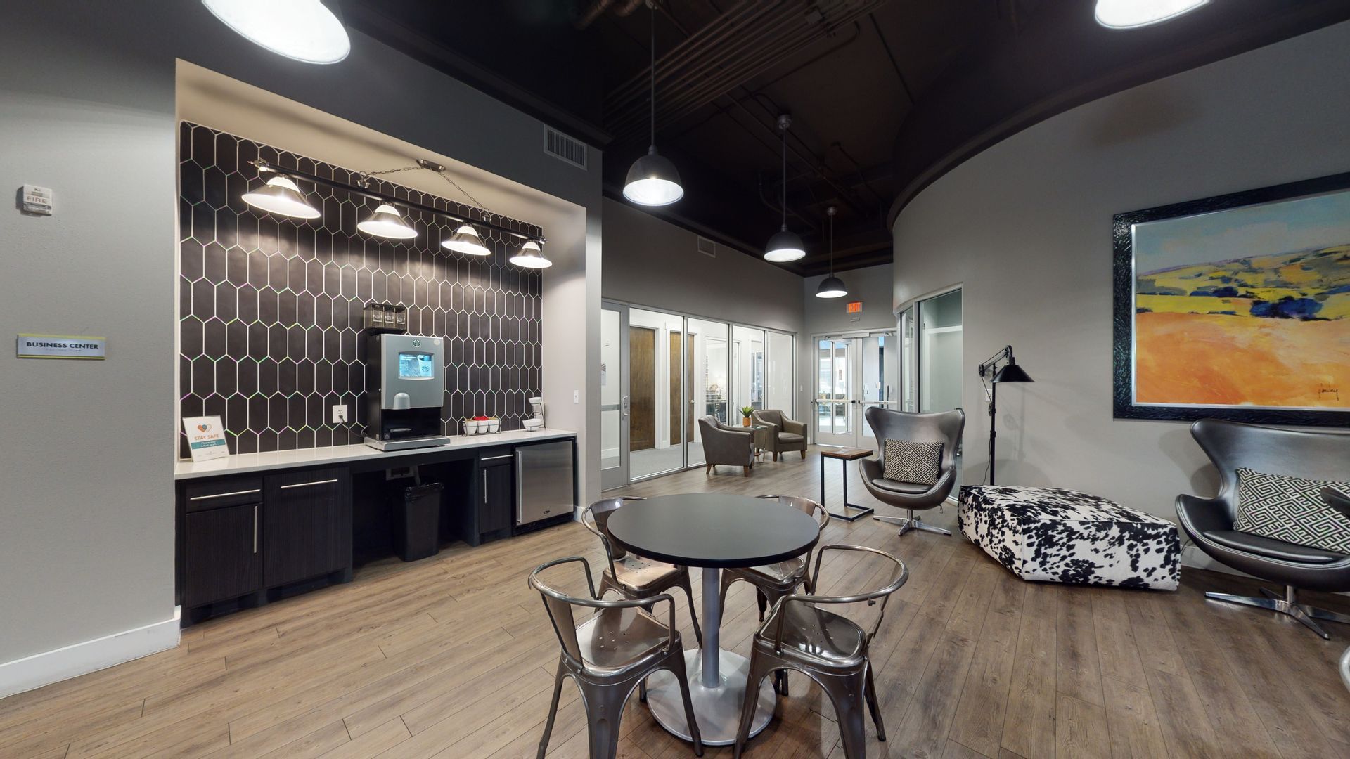 There is a table and chairs in the middle of the room.