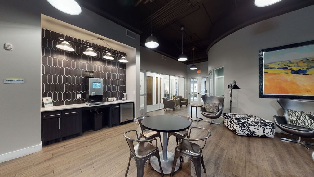 There is a table and chairs in the middle of the room.