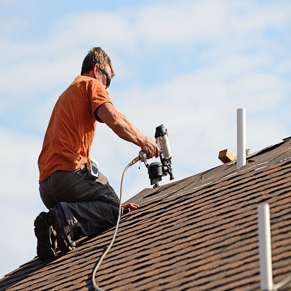 worker installing roofing