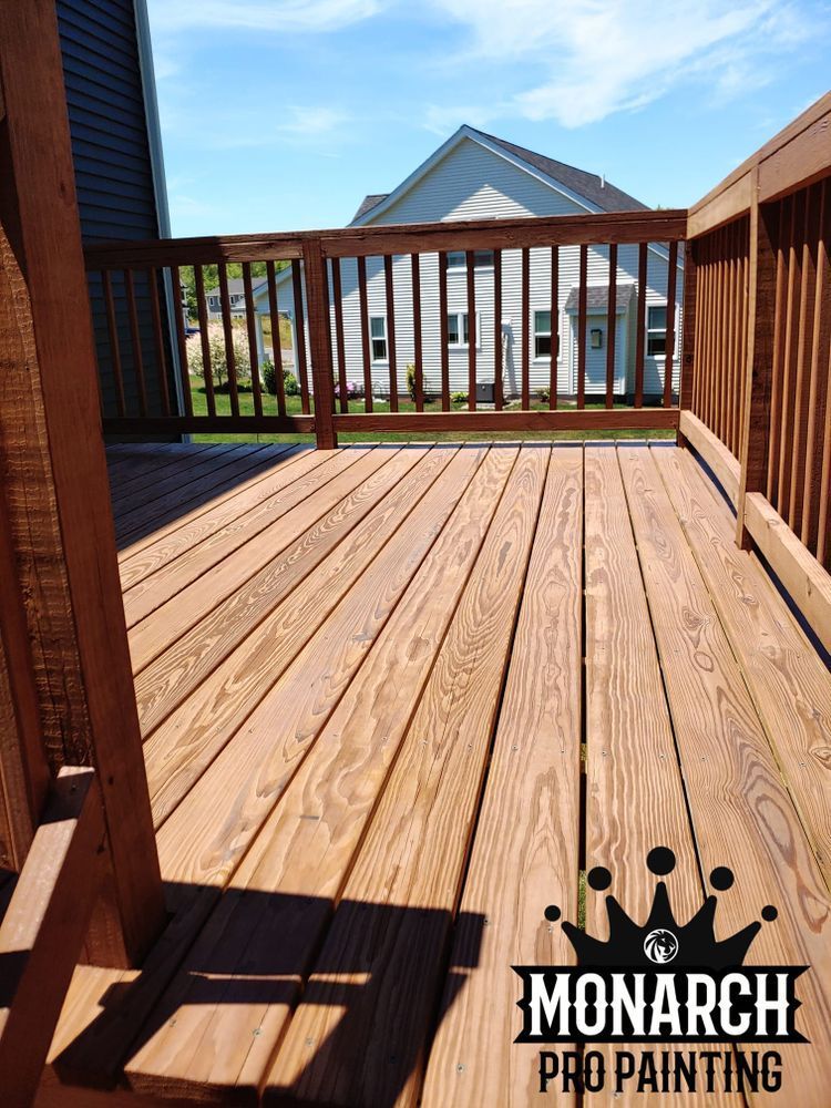 A monarch pro painting logo is on a wooden deck