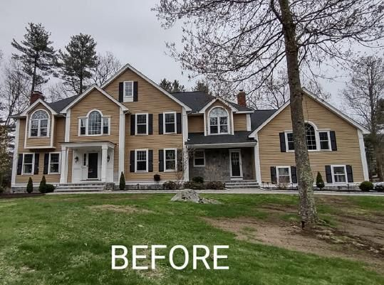 A before picture of a house with a tree in front of it