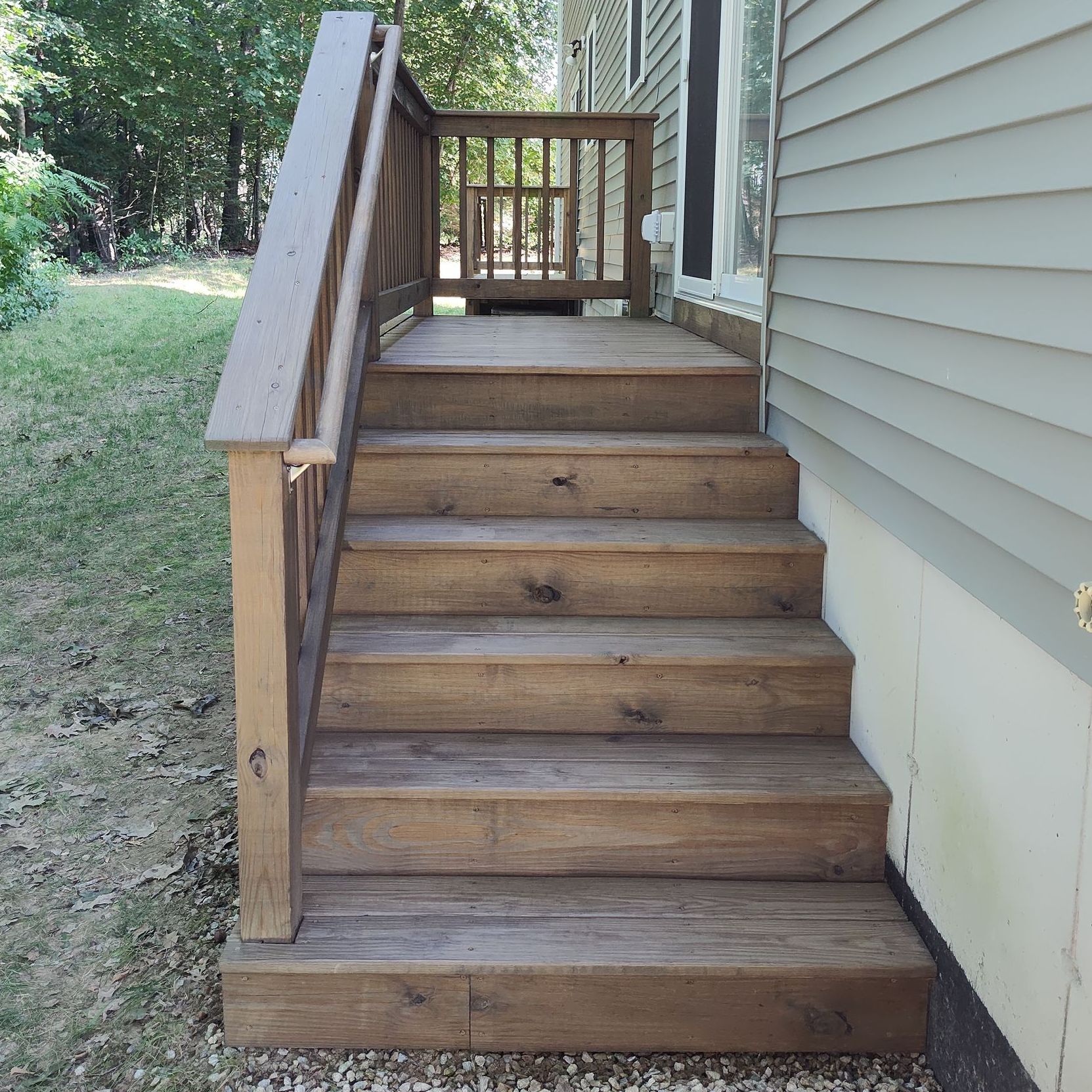 A wooden deck with stairs leading up to it