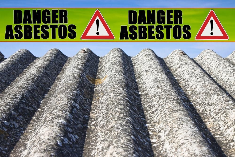 A Roof with Danger Asbestos Signs on It — Ballina Demolitions In East Wardell, NSW