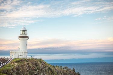 A Lighthouse Is Sitting On Top Of A Cliff  — Ballina Demolitions In Byron Bay, NSW