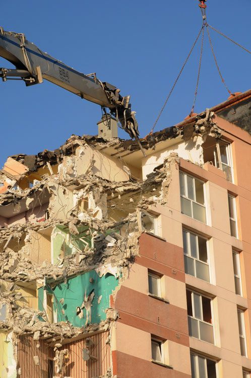 A Large Building Is Being Demolished By A Crane — Ballina Demolitions In Casino, NSW