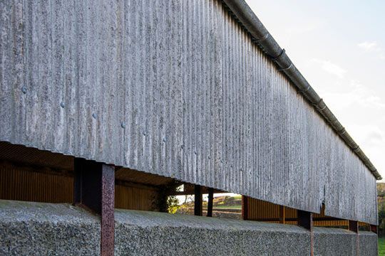 A Close Up Of The Side Of A Building With A Corrugated Metal Roof — Ballina Demolitions In East Wardell, NSW