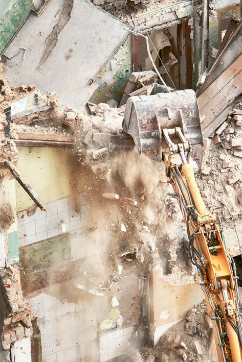 A Bulldozer Is Demolishing A Building With A Lot Of Dust Coming Out Of It — Ballina Demolitions In Murwillumbah, NSW
