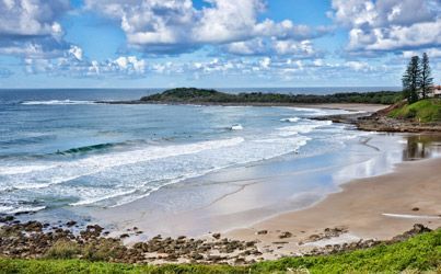 A Beach With Waves Crashing On The Shore On A Sunny Day — Ballina Demolitions In Yamba, NSW