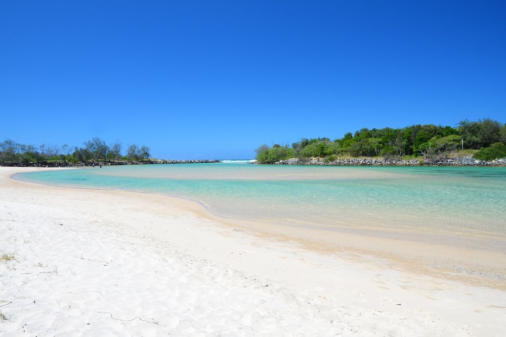 A White Sandy Beach With A Body Of Water In The Background — Ballina Demolitions In Pottsville, NSW