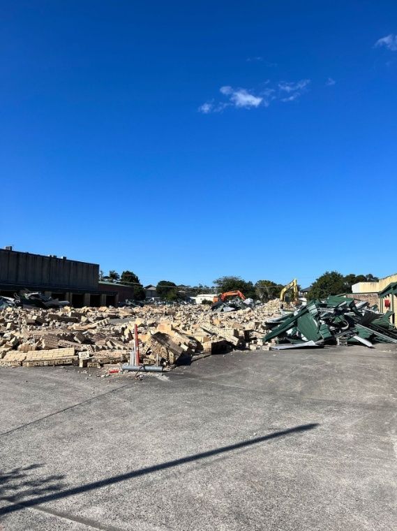 A Large Pile Of Trash Is Sitting On The Ground In A Parking Lot — Ballina Demolitions In East Wardell, NSW