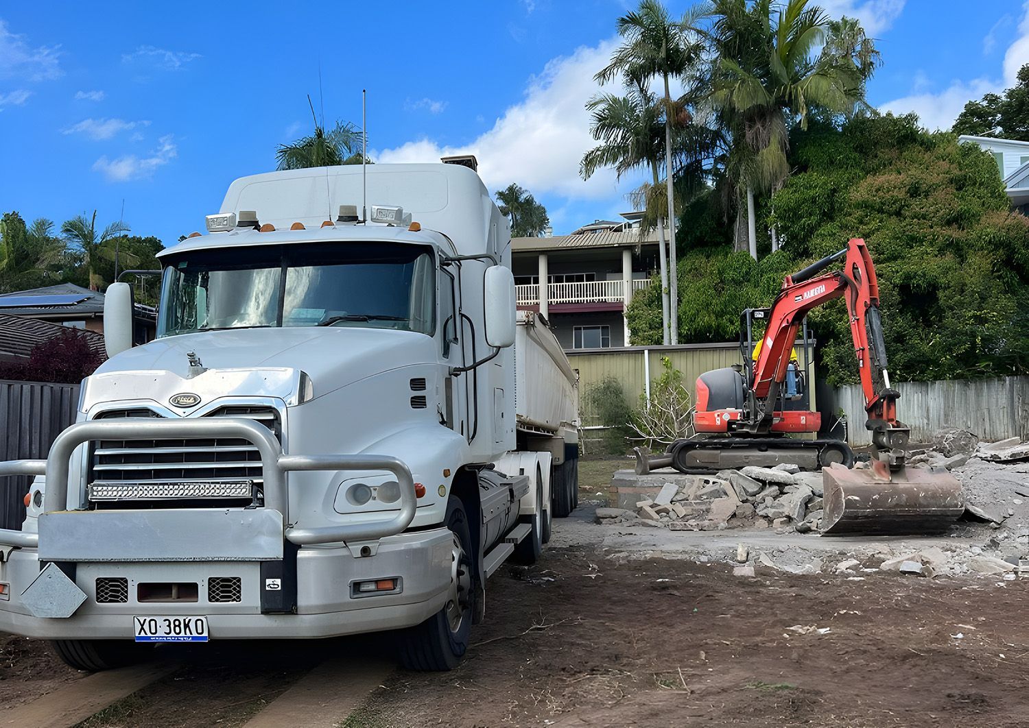 Excavator And Truck Performing Building Demolition