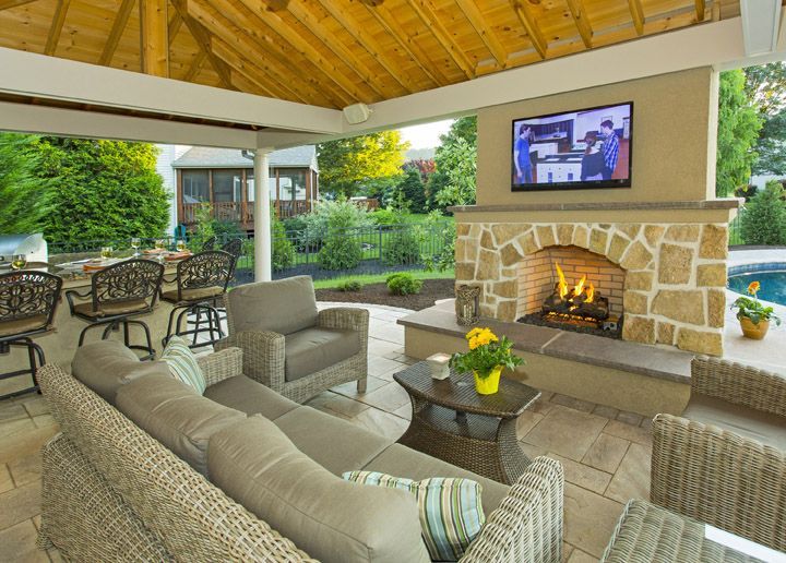 A living room with a fireplace and a television on the wall.