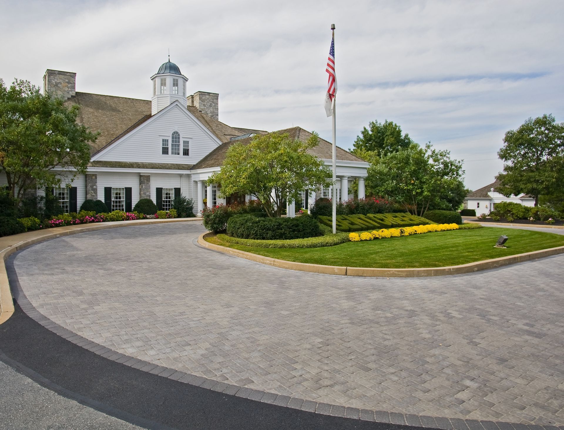 A large white house with a flag in front of it