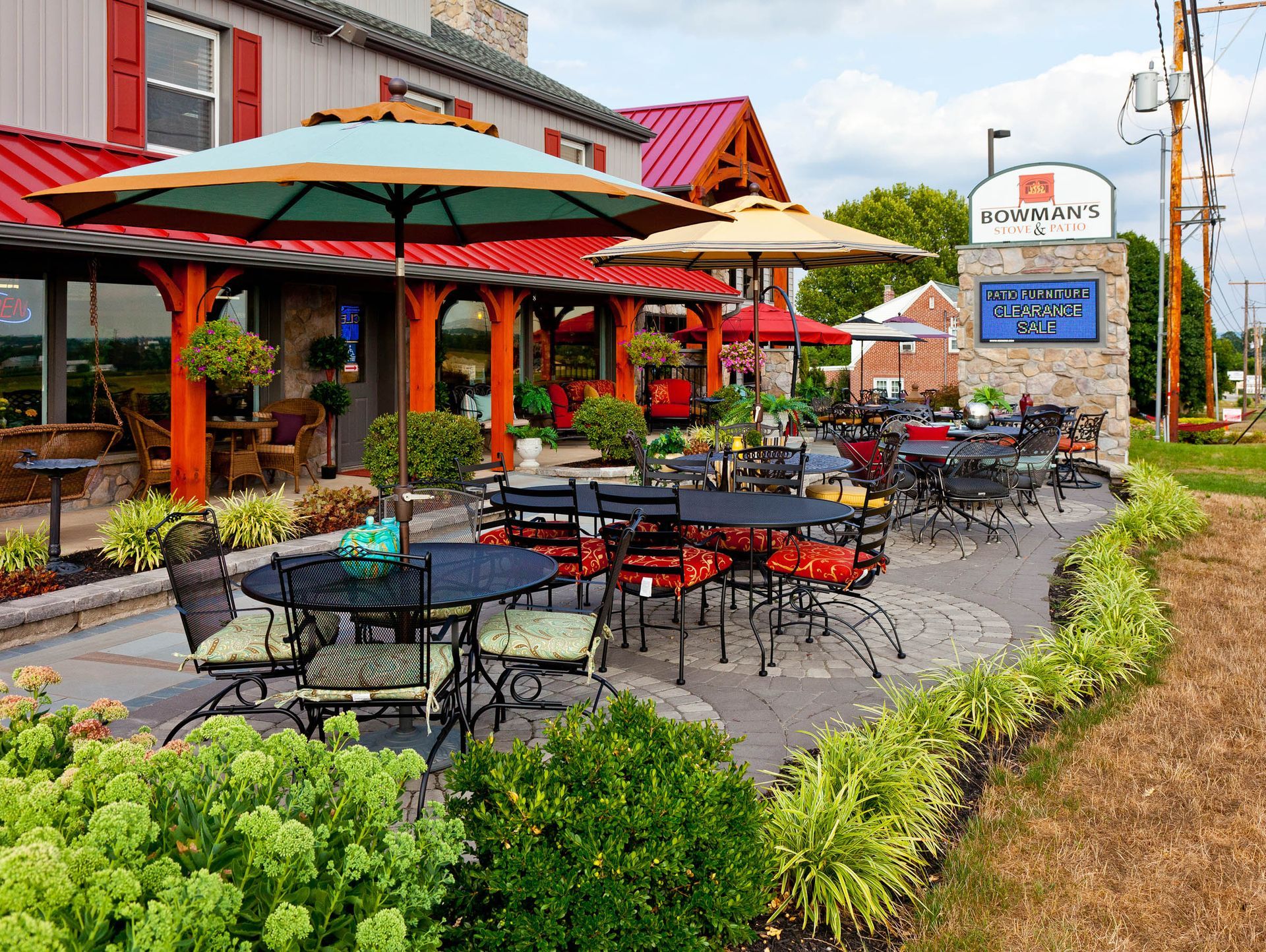 A restaurant with tables and chairs and umbrellas outside
