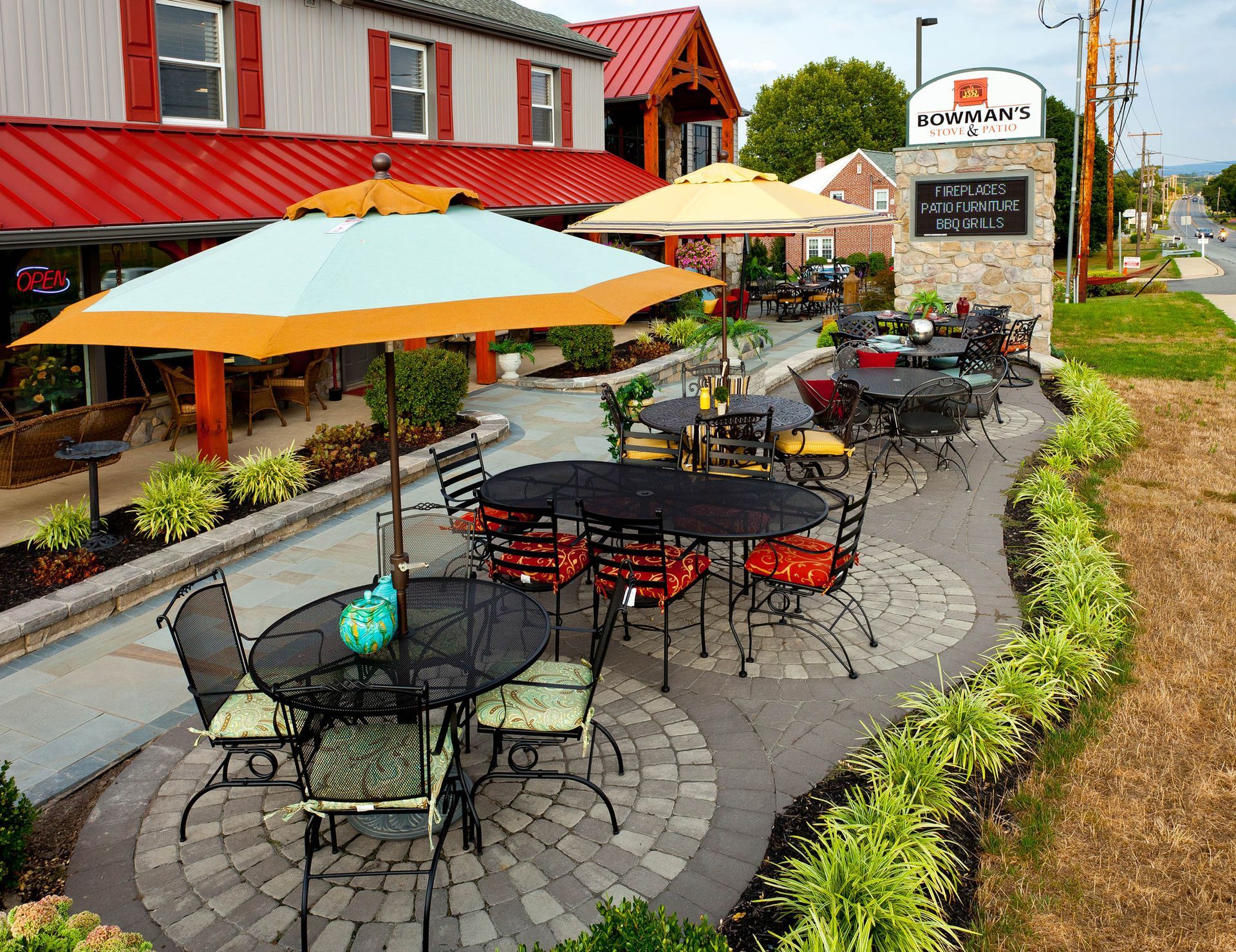 A restaurant with tables and chairs and umbrellas outside
