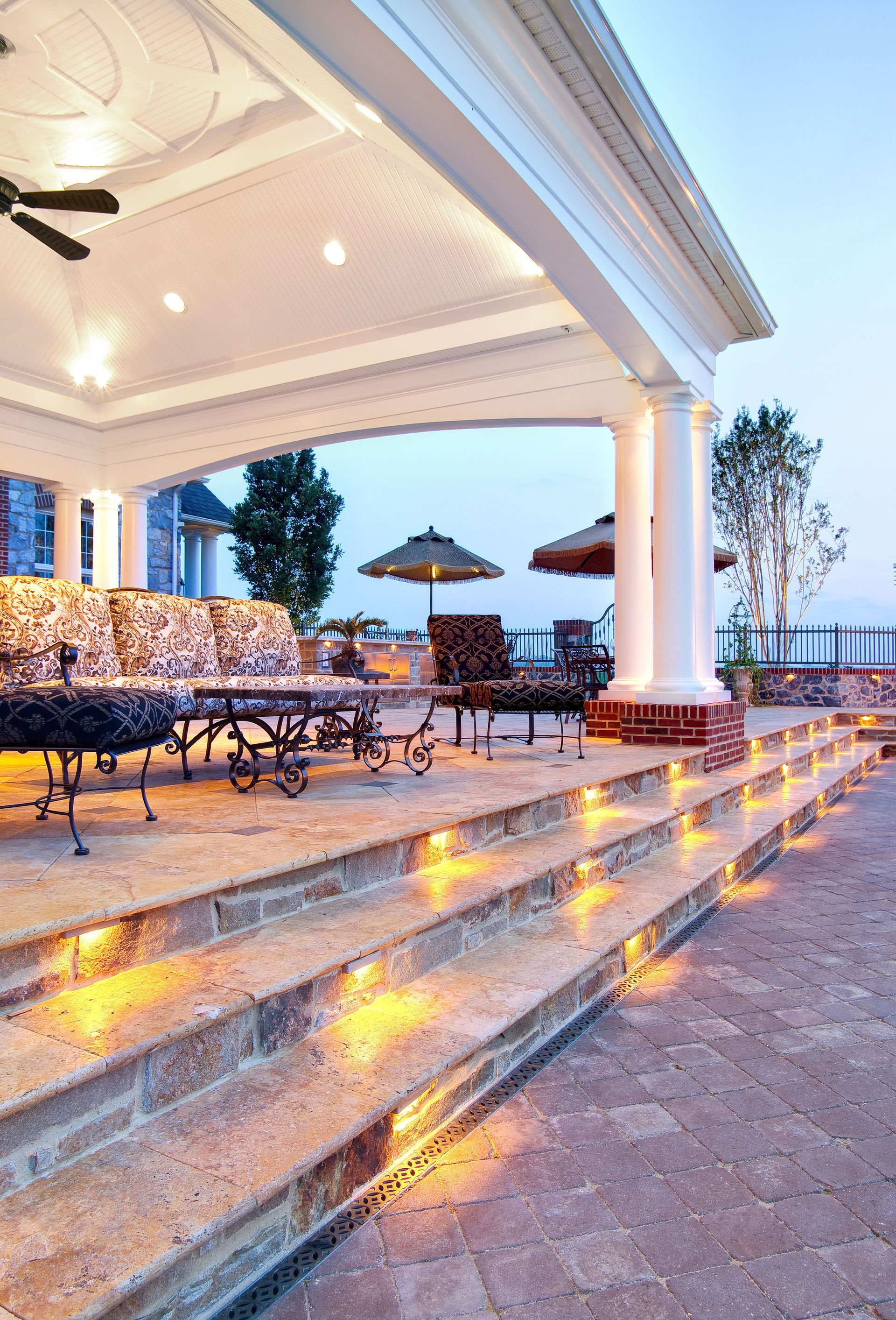 A gazebo with stairs leading up to it and a ceiling fan.