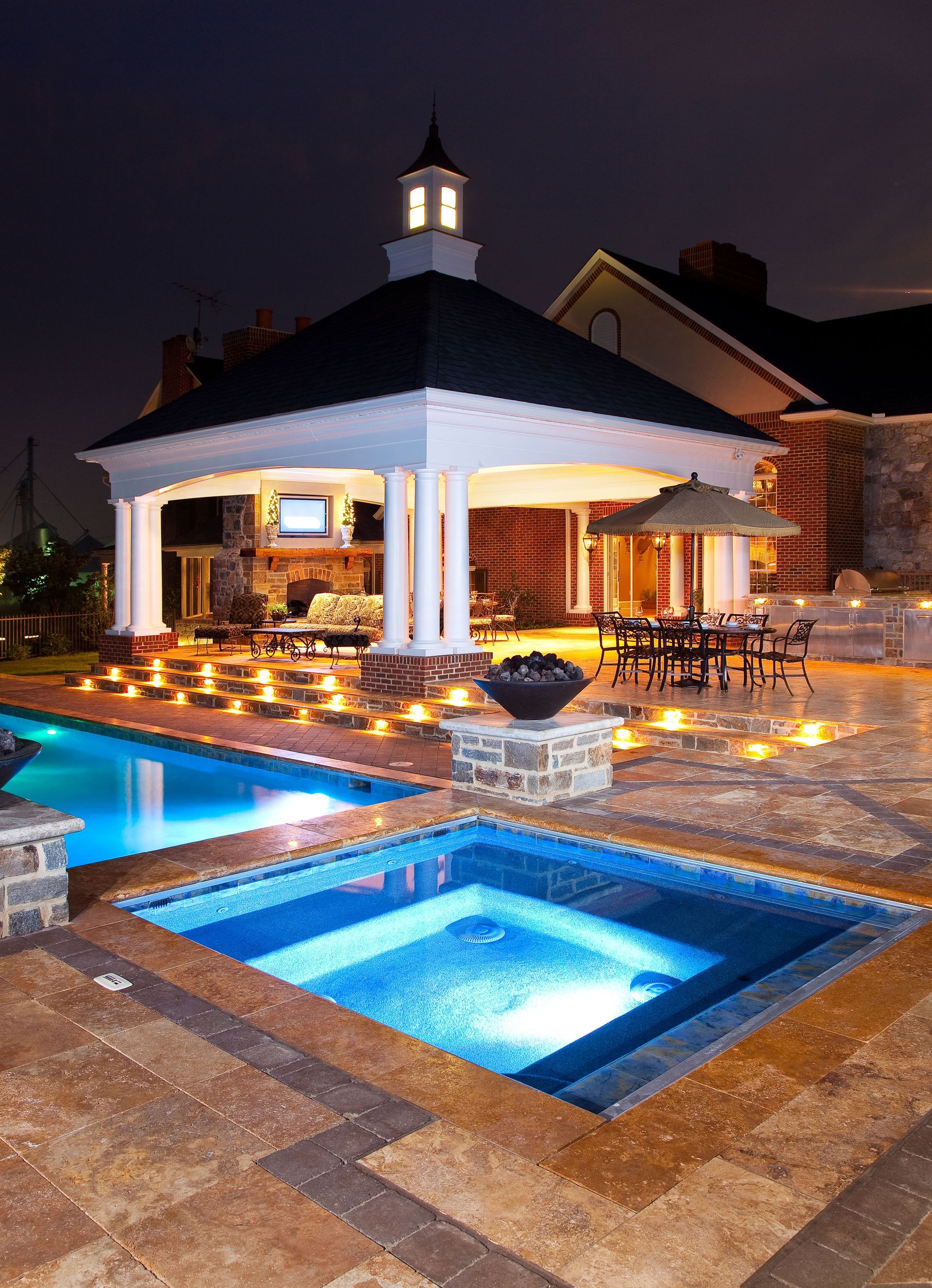 A large swimming pool with a gazebo in the background