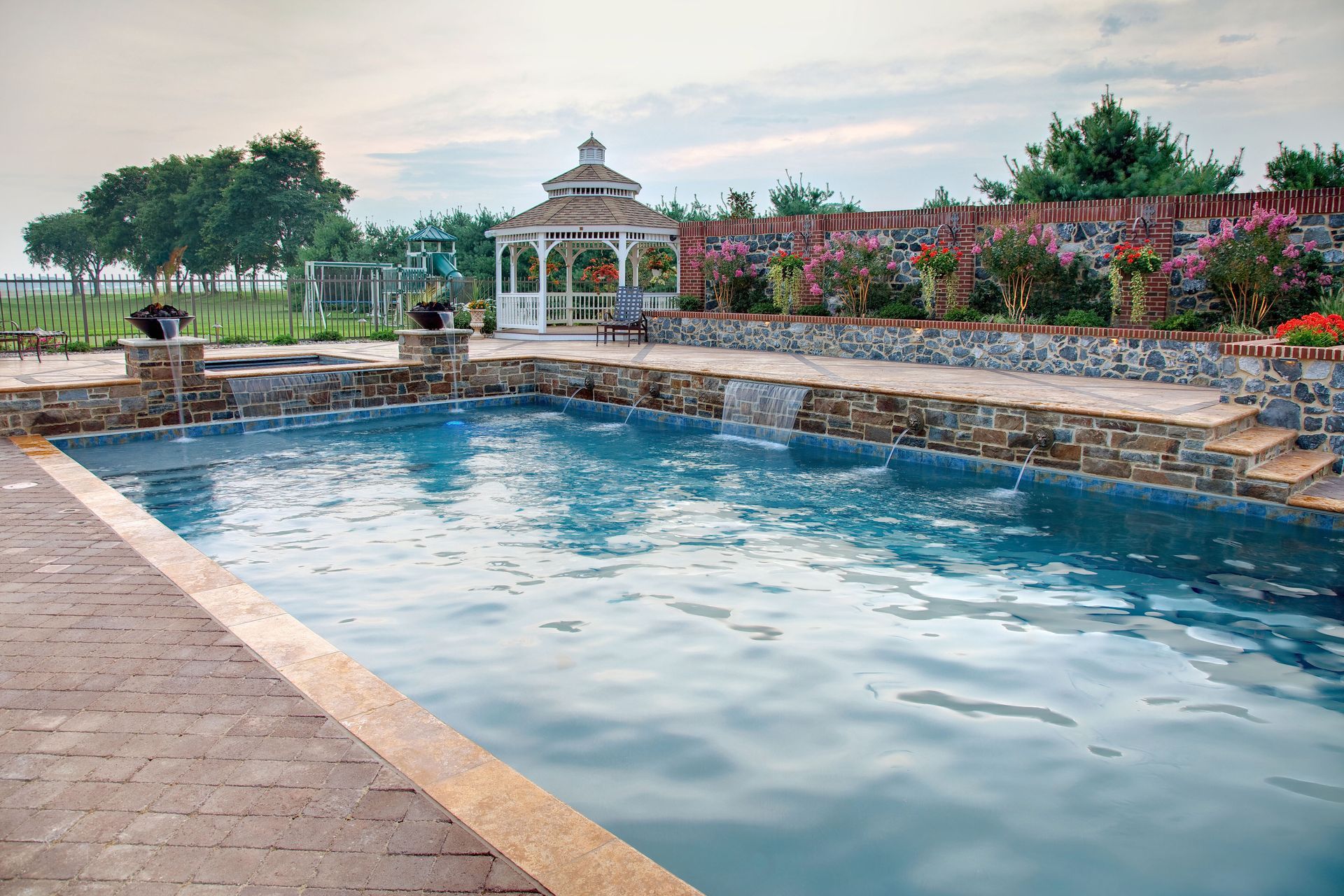 A large swimming pool with a gazebo in the background.