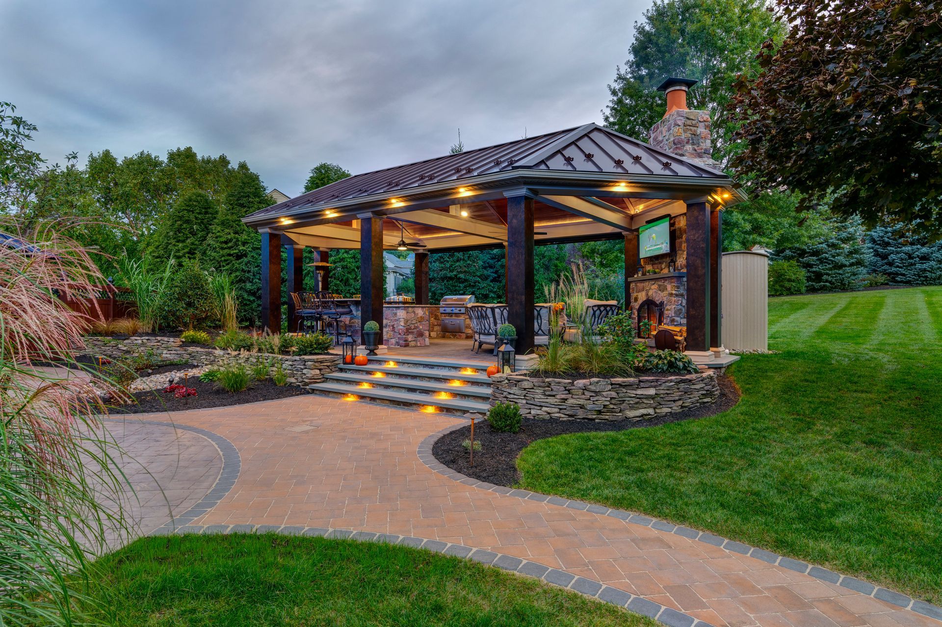There is a gazebo in the middle of a lush green field.