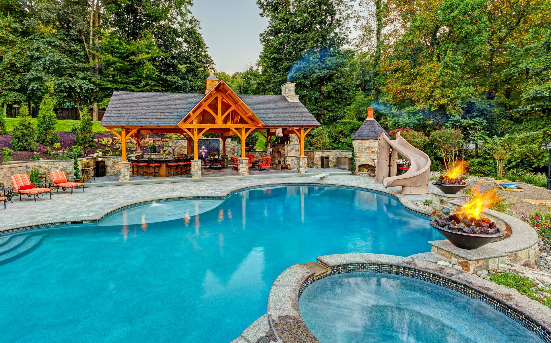 A large swimming pool with a gazebo and a fire pit in the backyard.