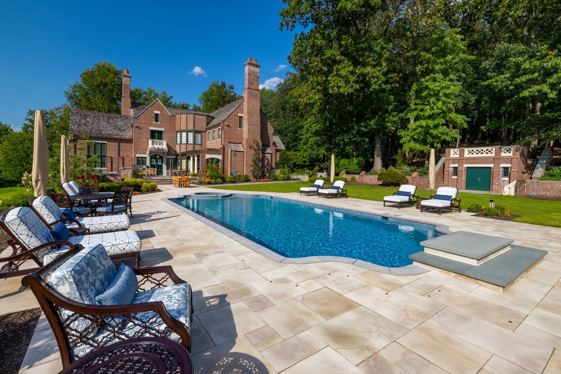 A large house with a large swimming pool in front of it