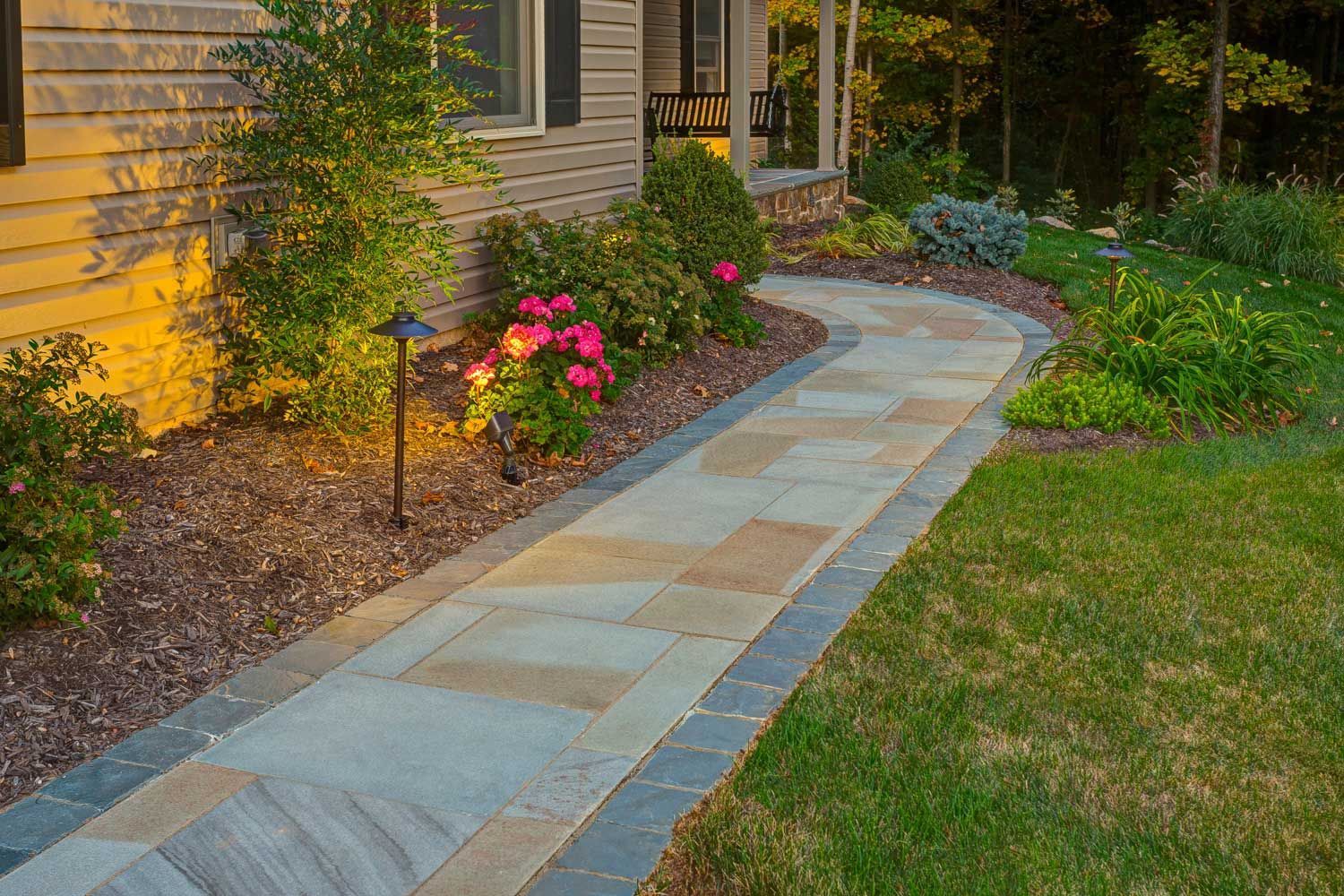 A stone walkway leading to the front door of a house.