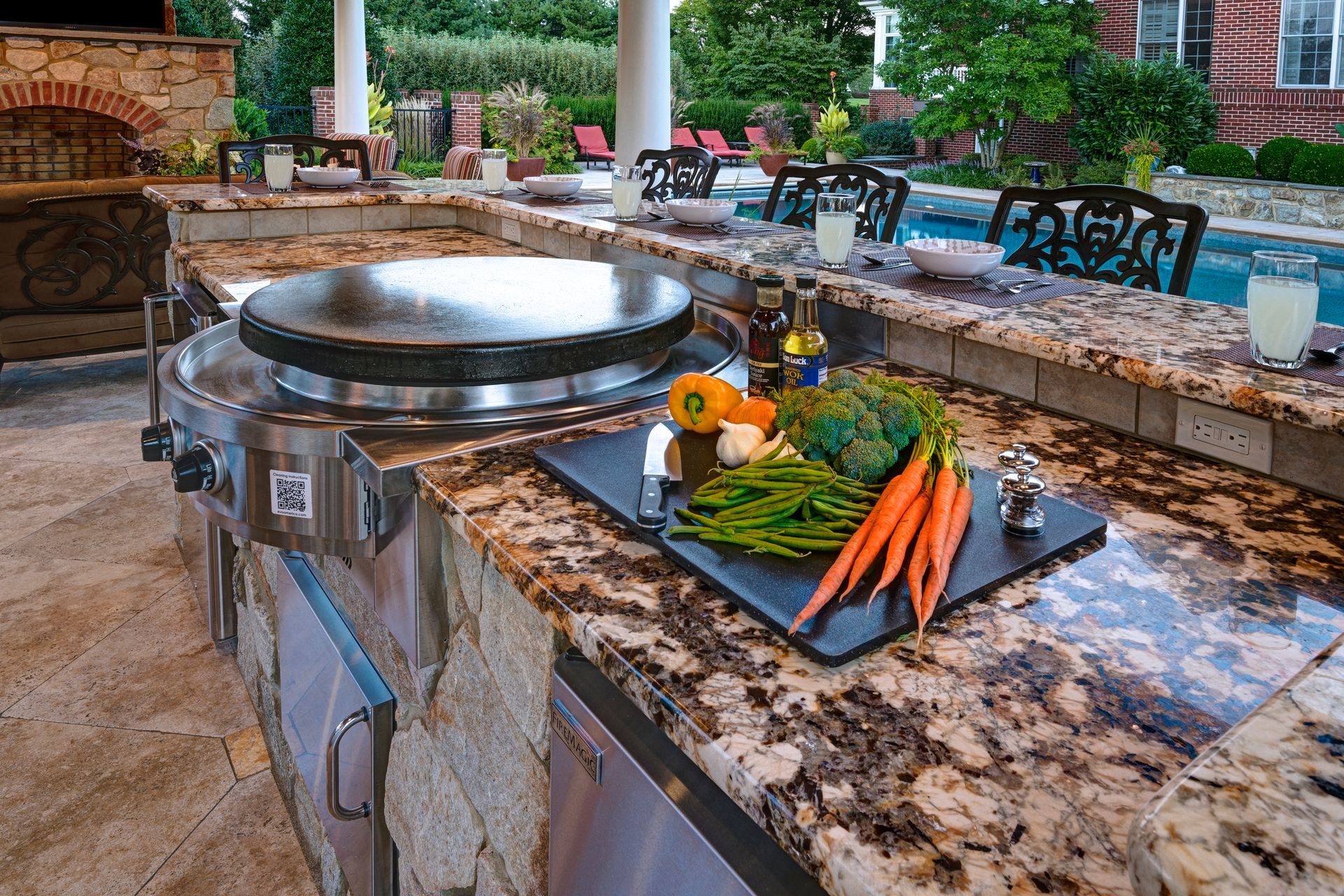 A kitchen counter with vegetables and a grill on it