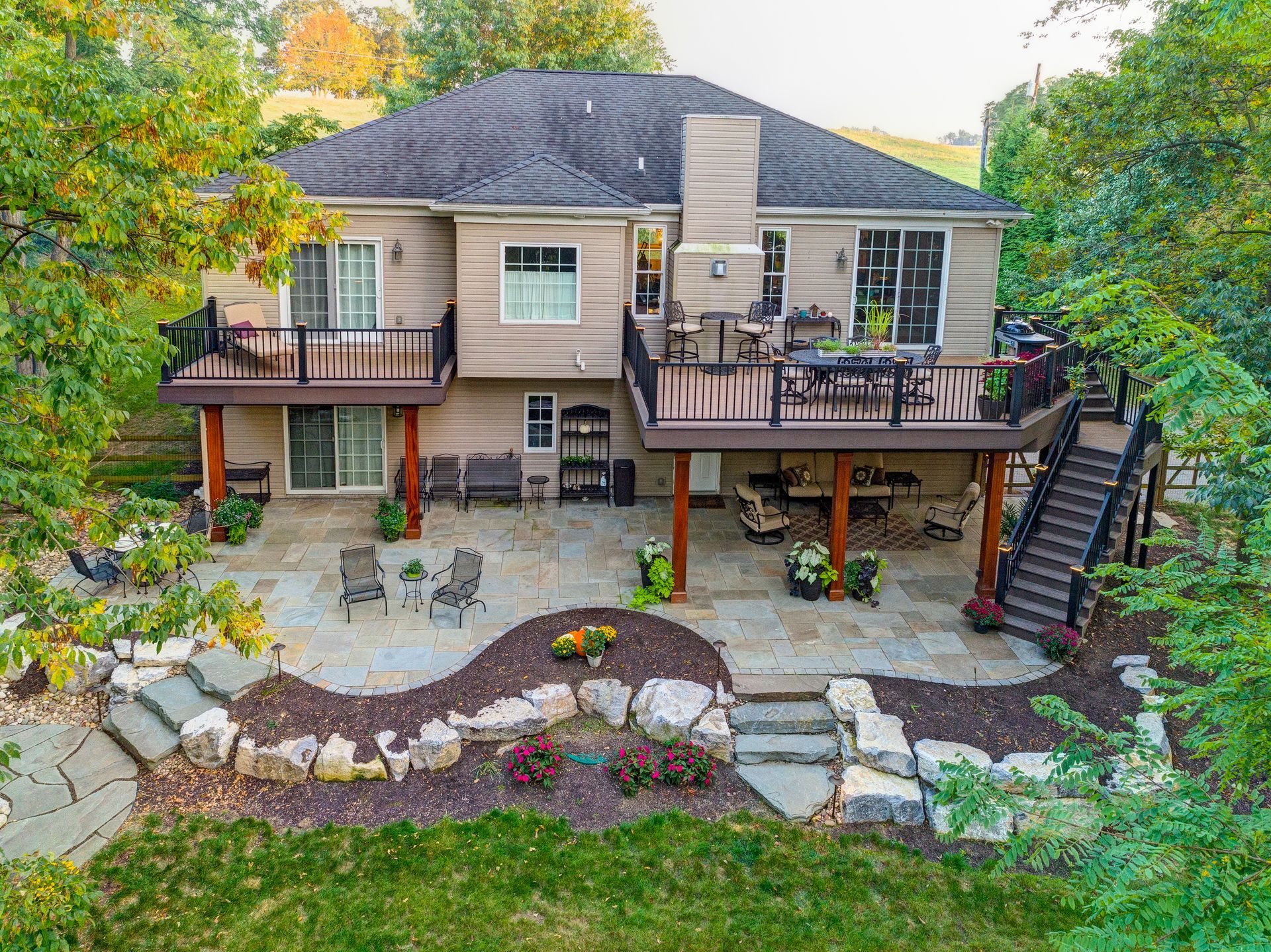An aerial view of a house with a large deck and patio.