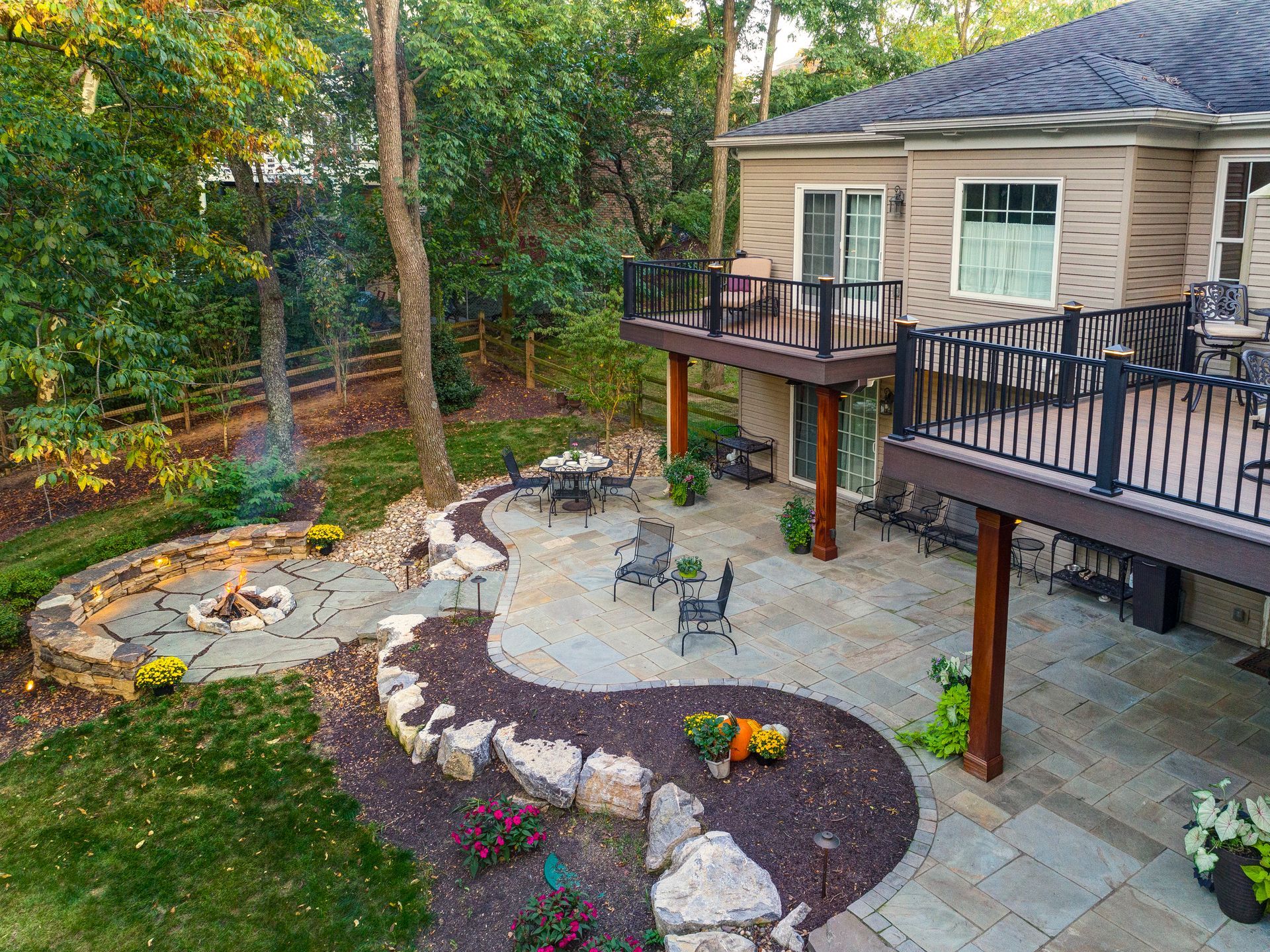 An aerial view of a house with a patio and a fire pit.