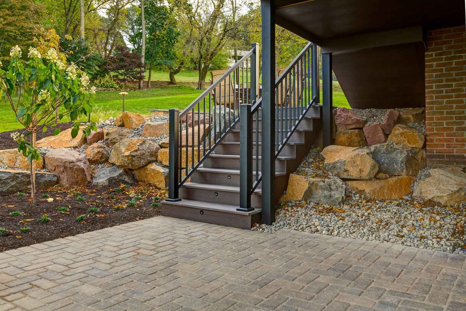 A set of stairs leading up to a brick patio.
