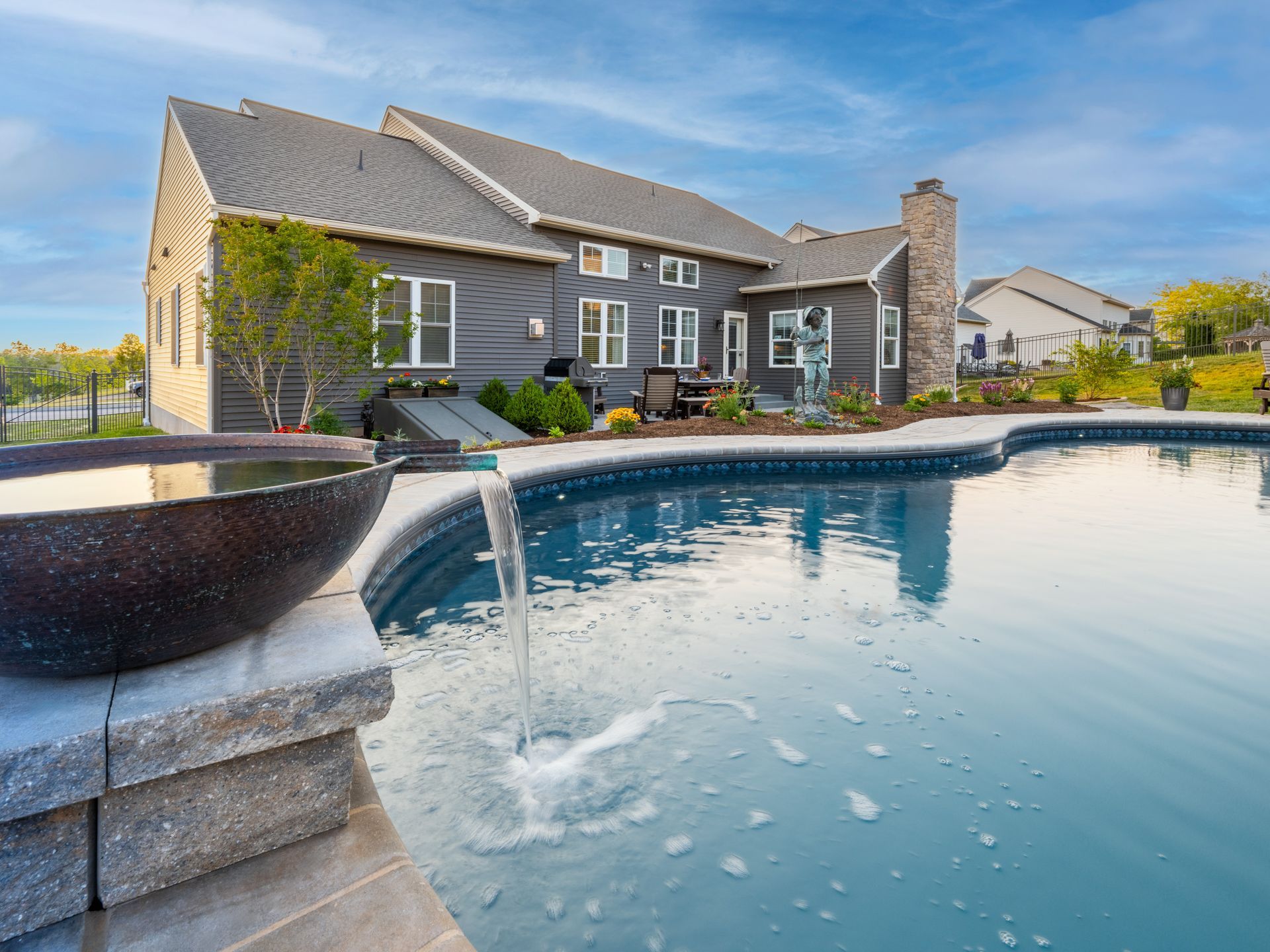 A large house with a swimming pool in front of it.