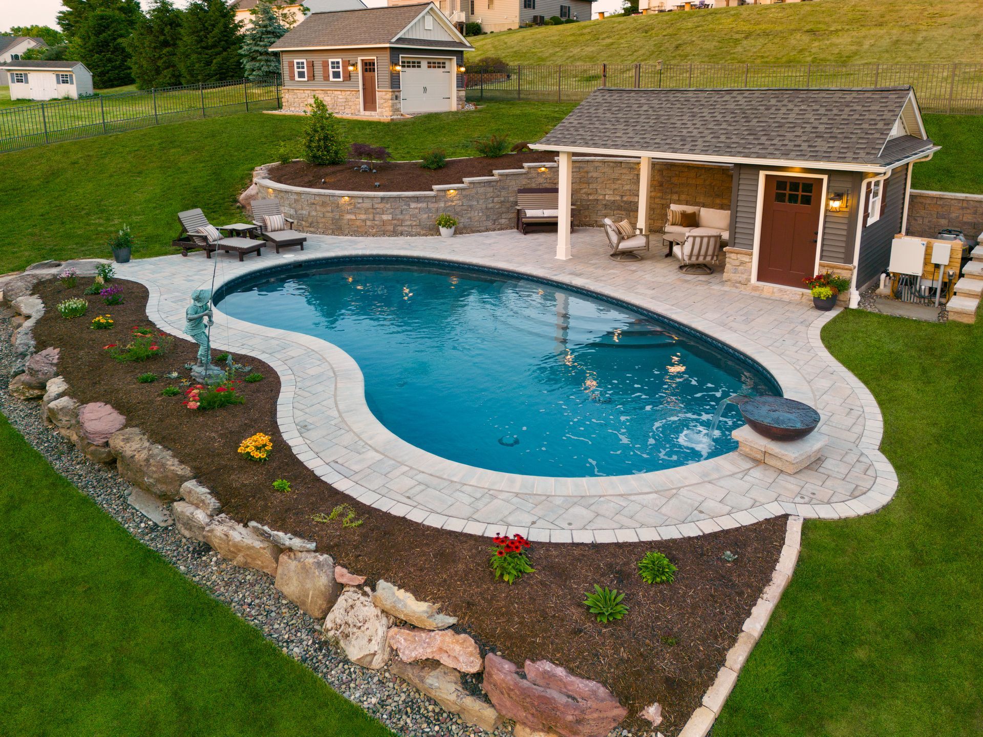 An aerial view of a large swimming pool in a backyard.