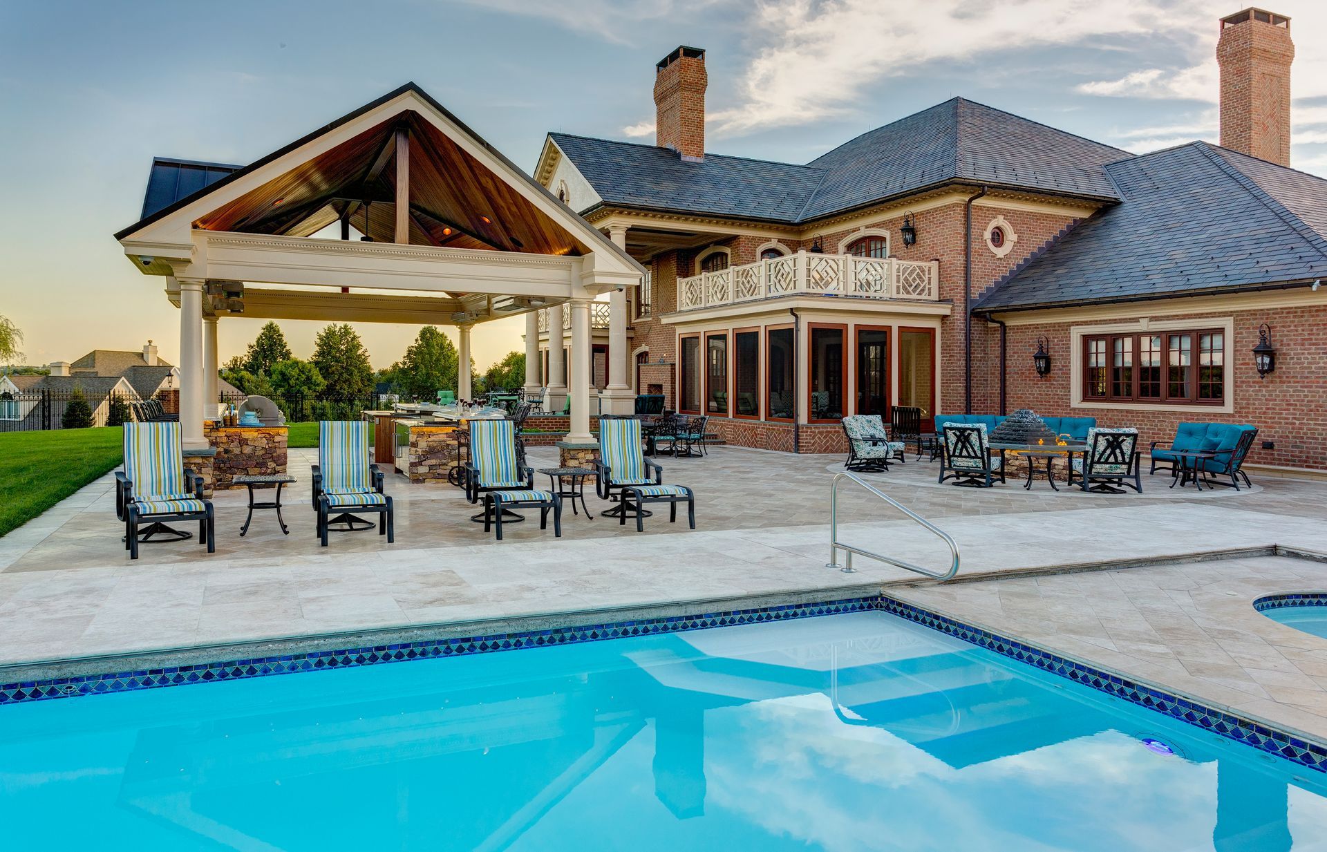 A large house with a large swimming pool in front of it.