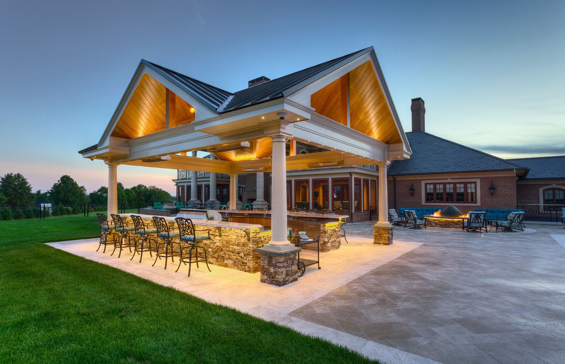 A large house with a large covered patio area in front of it.
