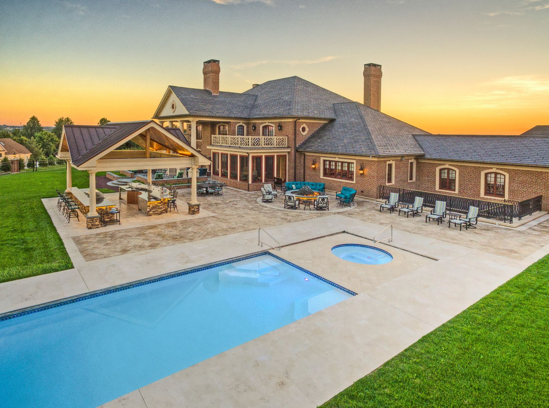 A large house with a large swimming pool in front of it.