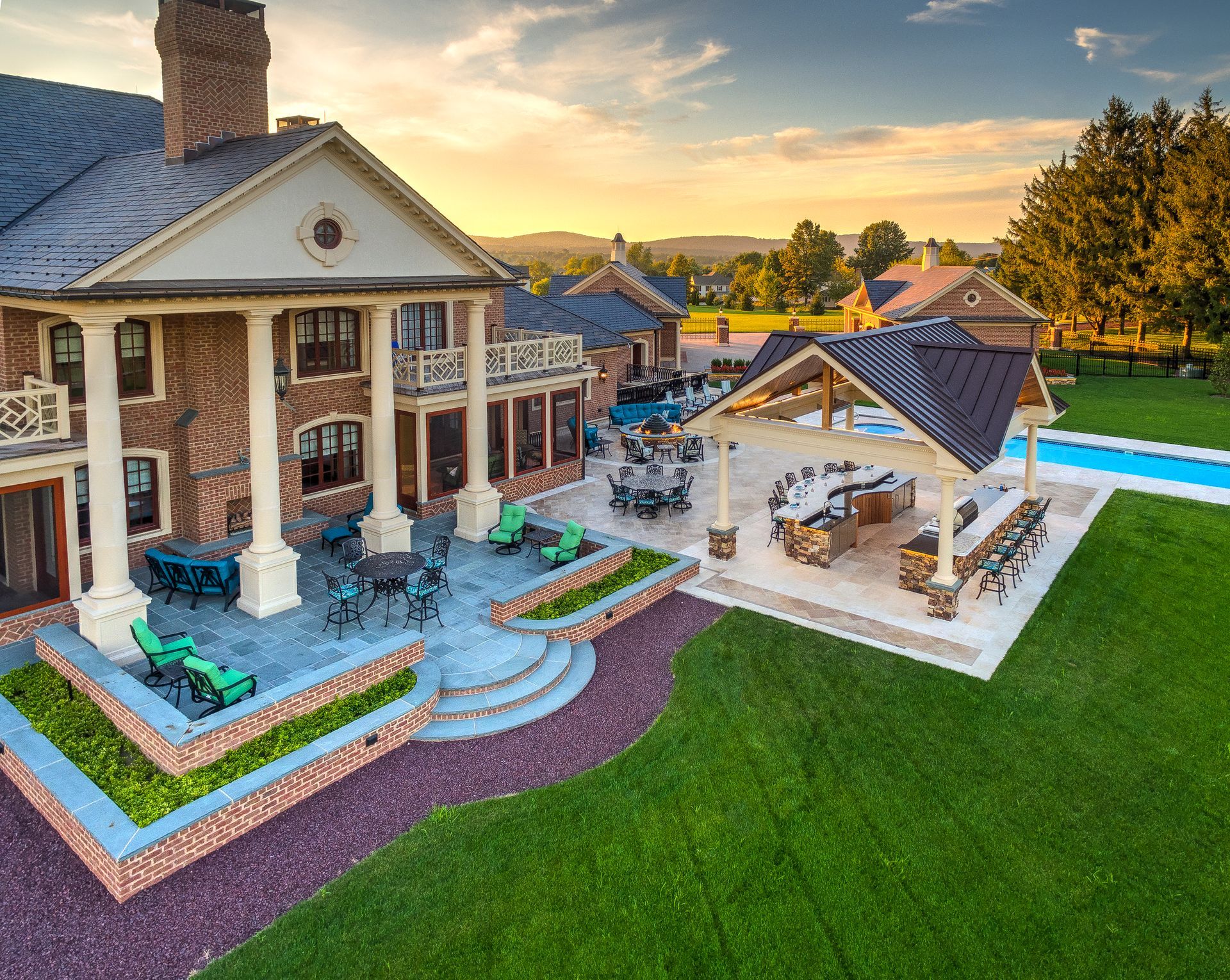 An aerial view of a large house with a swimming pool and patio area.