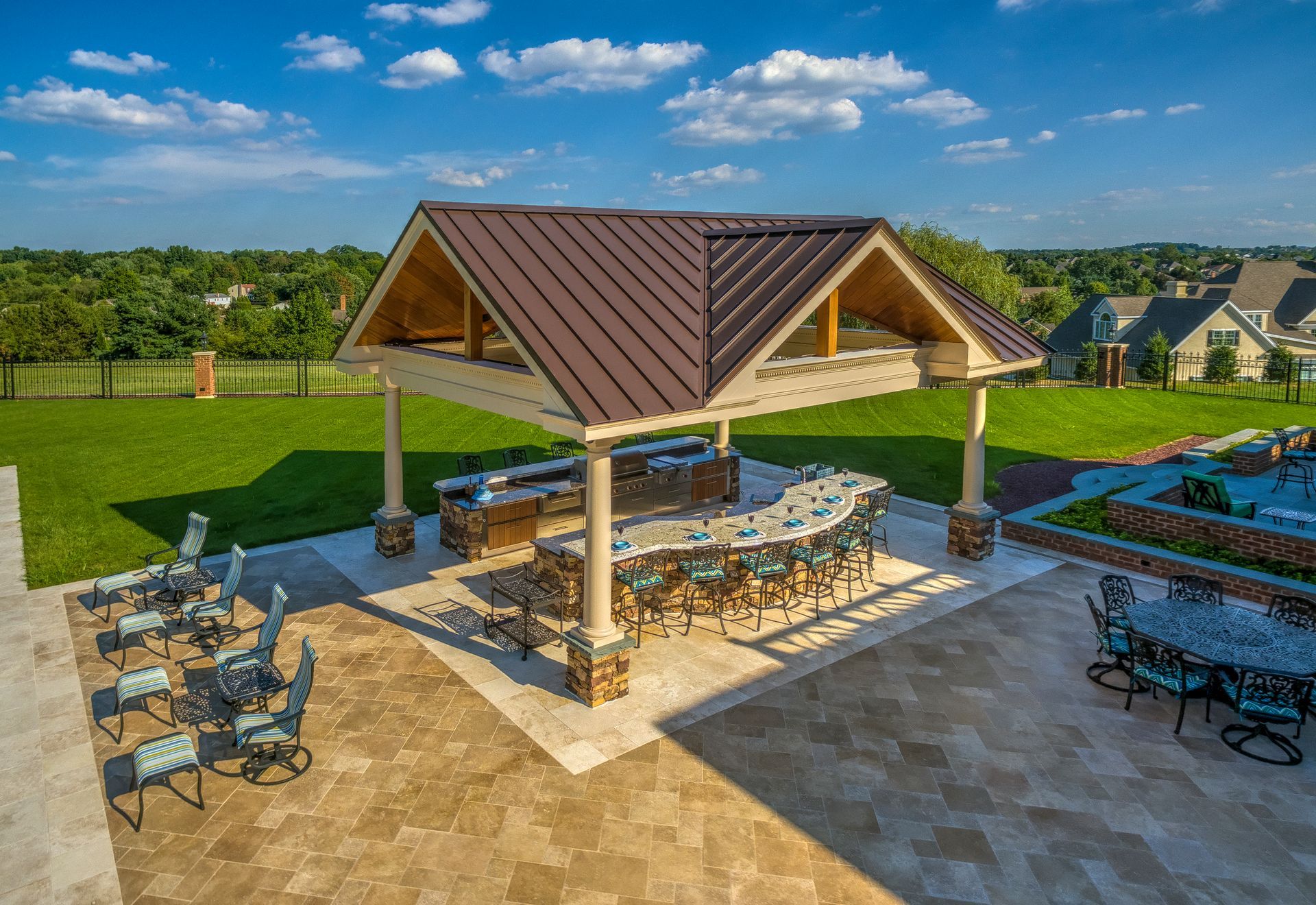 An aerial view of a patio area with tables and chairs under a pavilion.