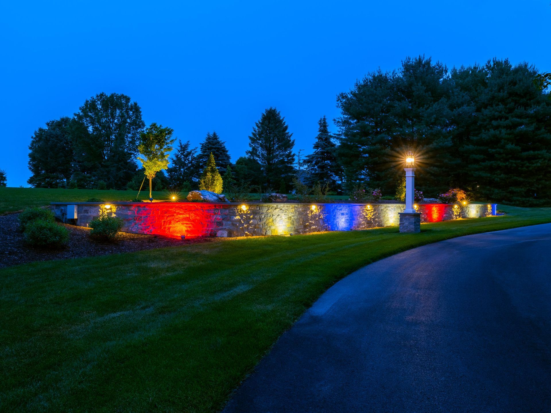 A driveway with red , white and blue lights on it